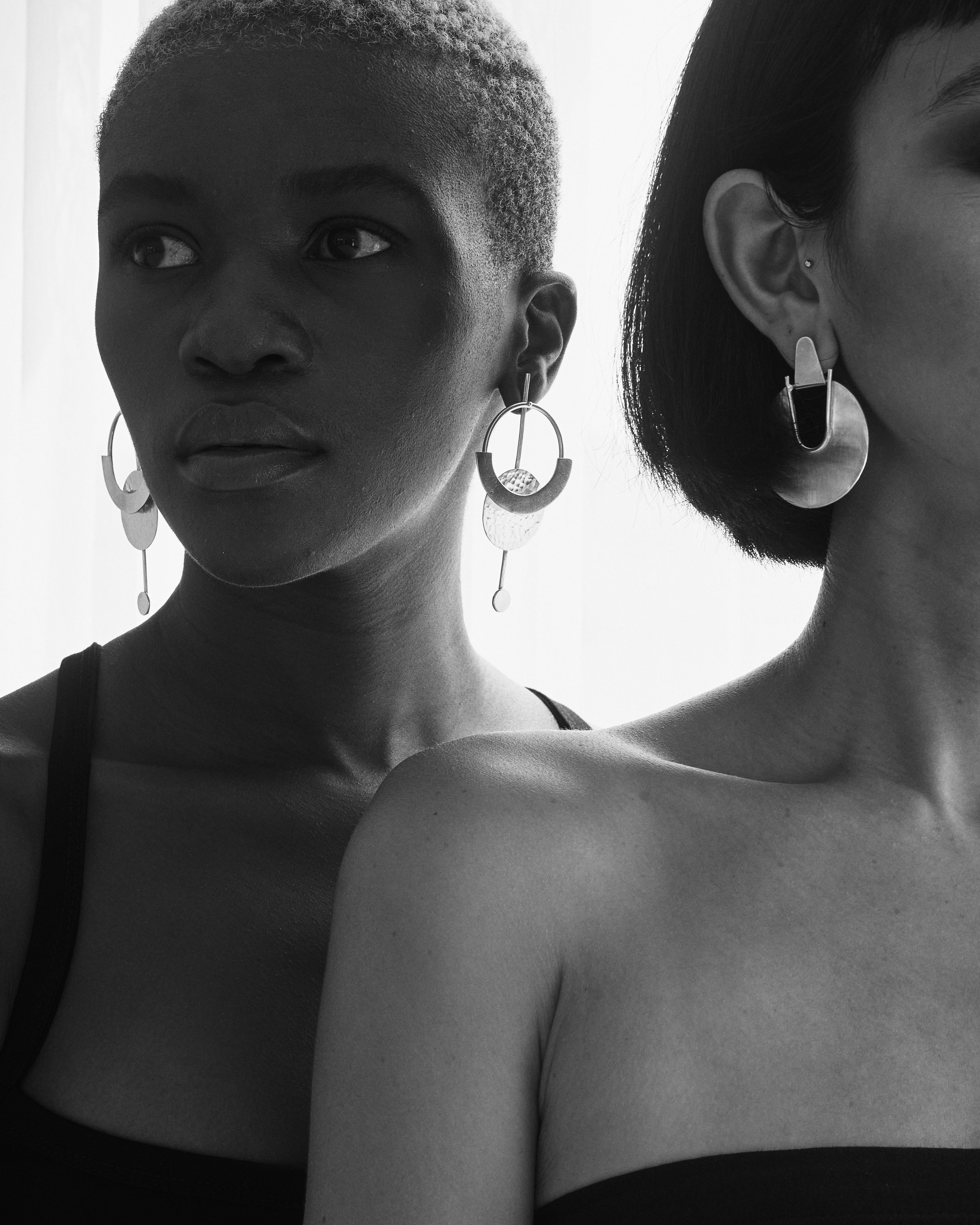 Editorial shots of Sasri wearing Elektra earring in silver medium and Thoko wearing Constellation earring in silver Larga