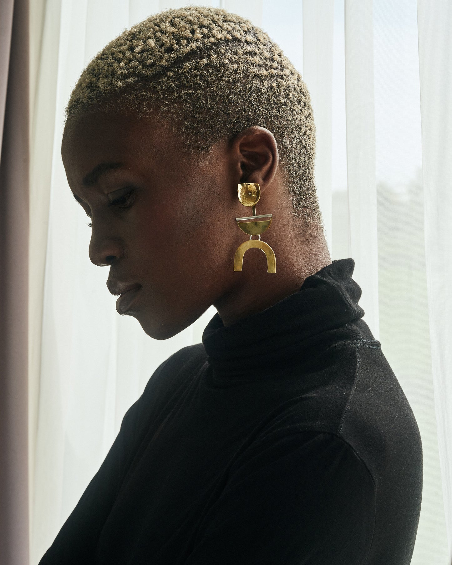 Beauty Shot of Thoko wearing The Dancers Earrings Brass