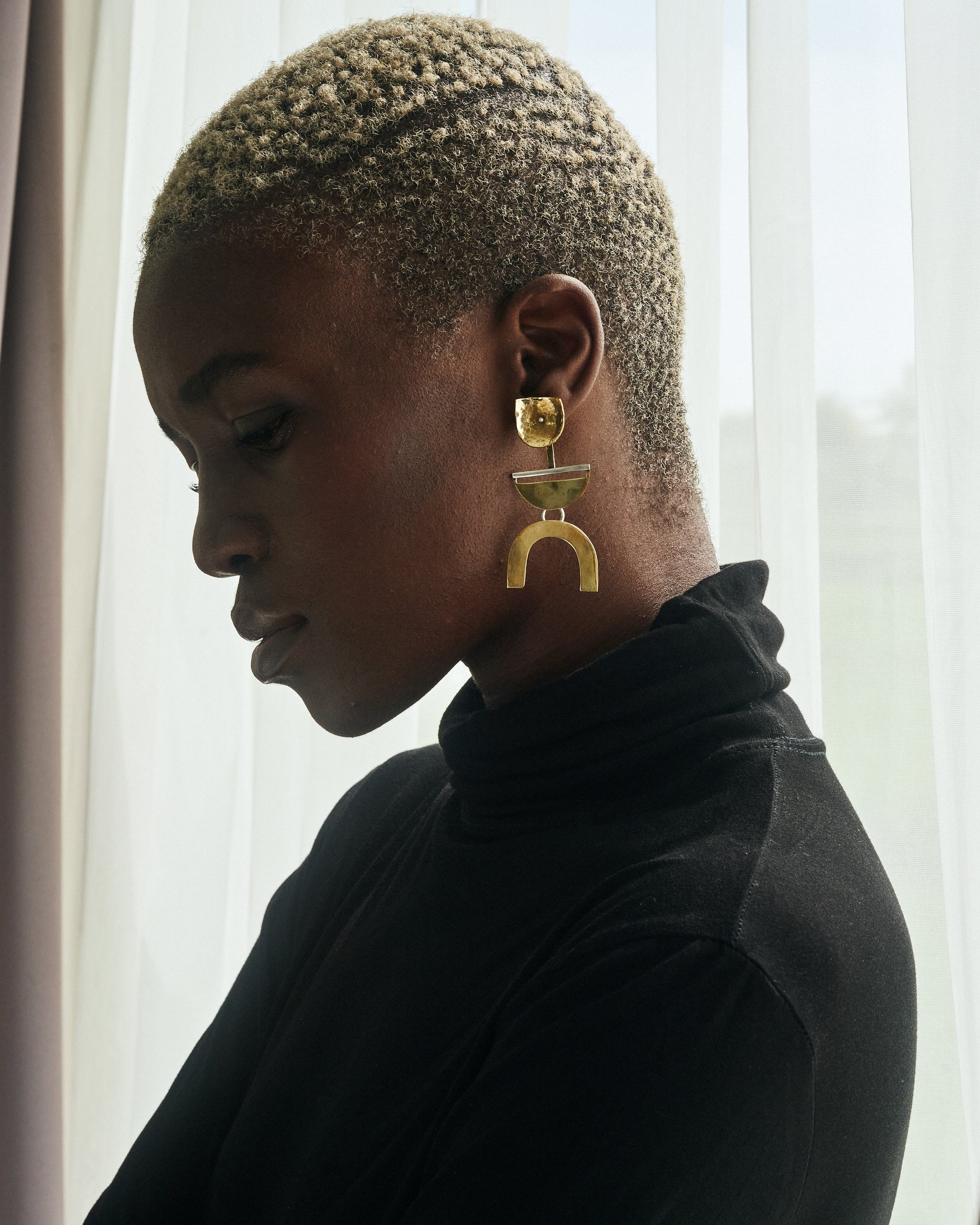 Beauty Shot of Thoko wearing The Dancers Earrings Brass