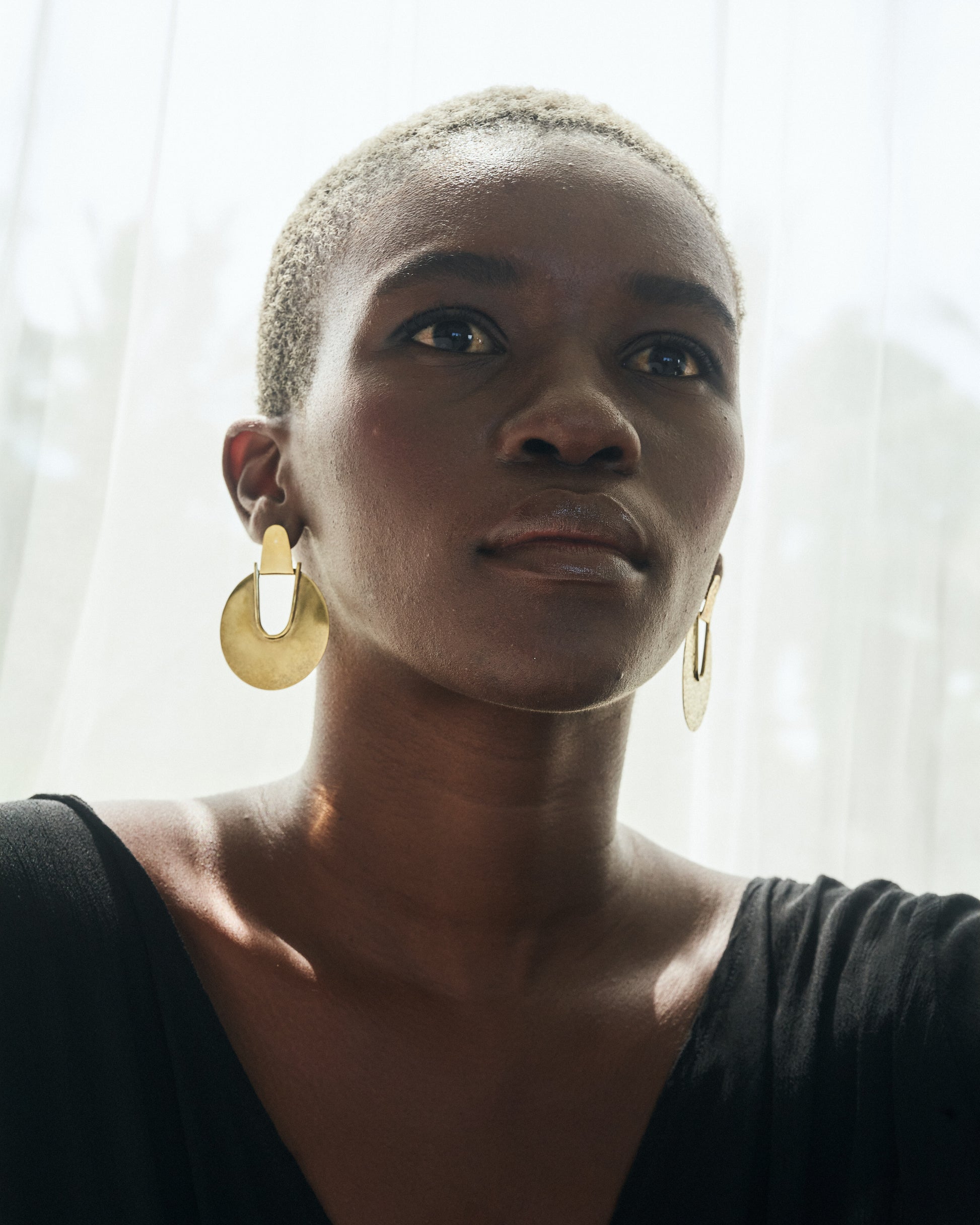 Beauty_shot_of_Thoko_wearing_Elektra_Earrings_Brass_Medium