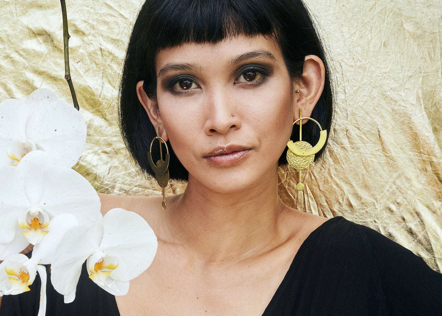 Beauty shot of Sasri wearing Elektra Earrings Brass Medium