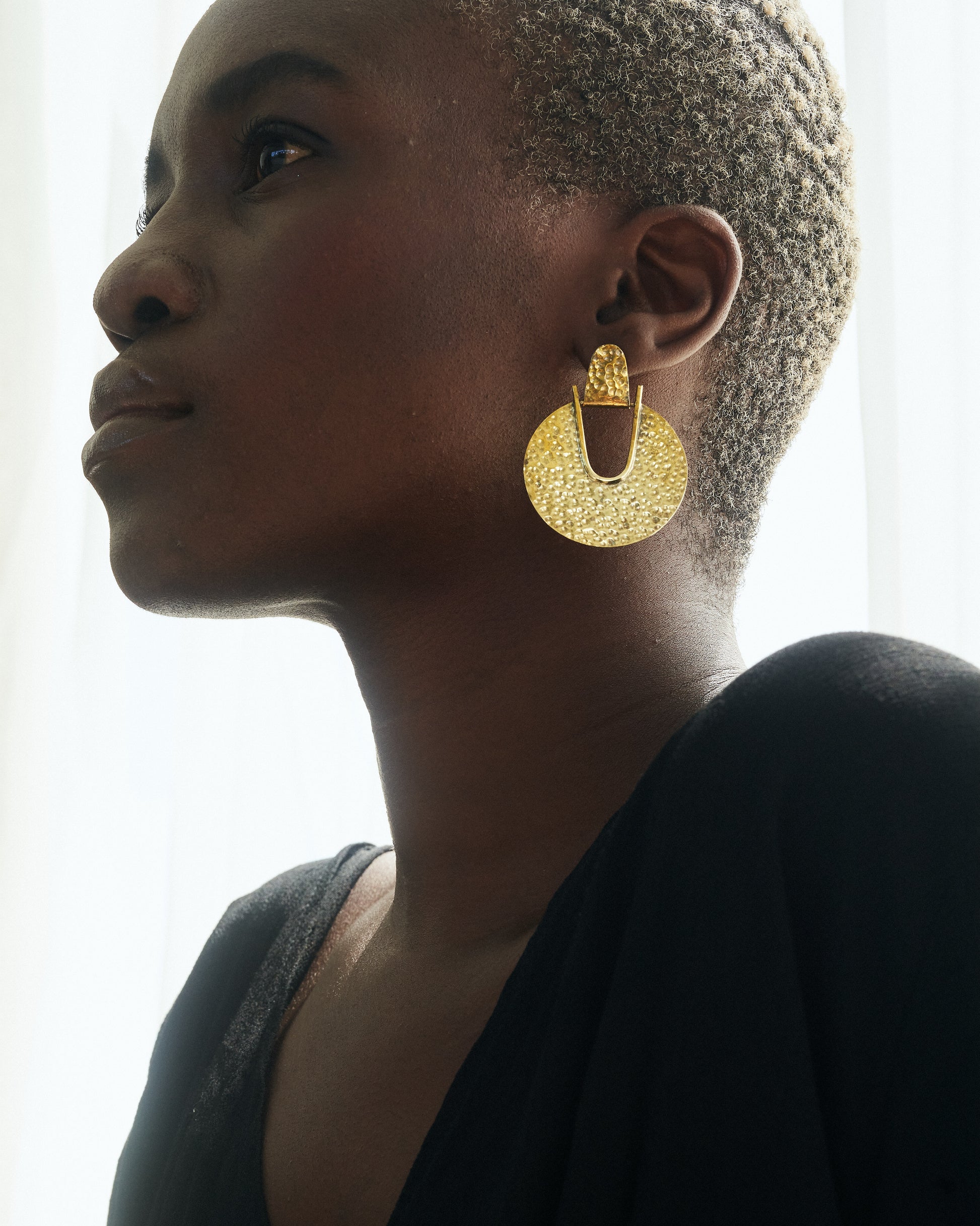 Beauty_shot_of_Thoko_wearing_Elektra_Earrings_Brass_Hammered_Medium