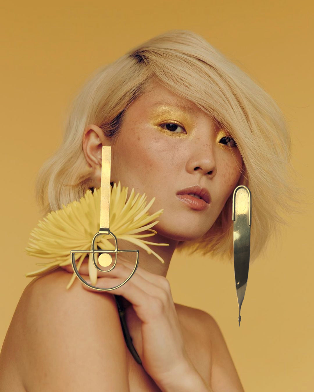 Asian woman wearing W&M brass earring